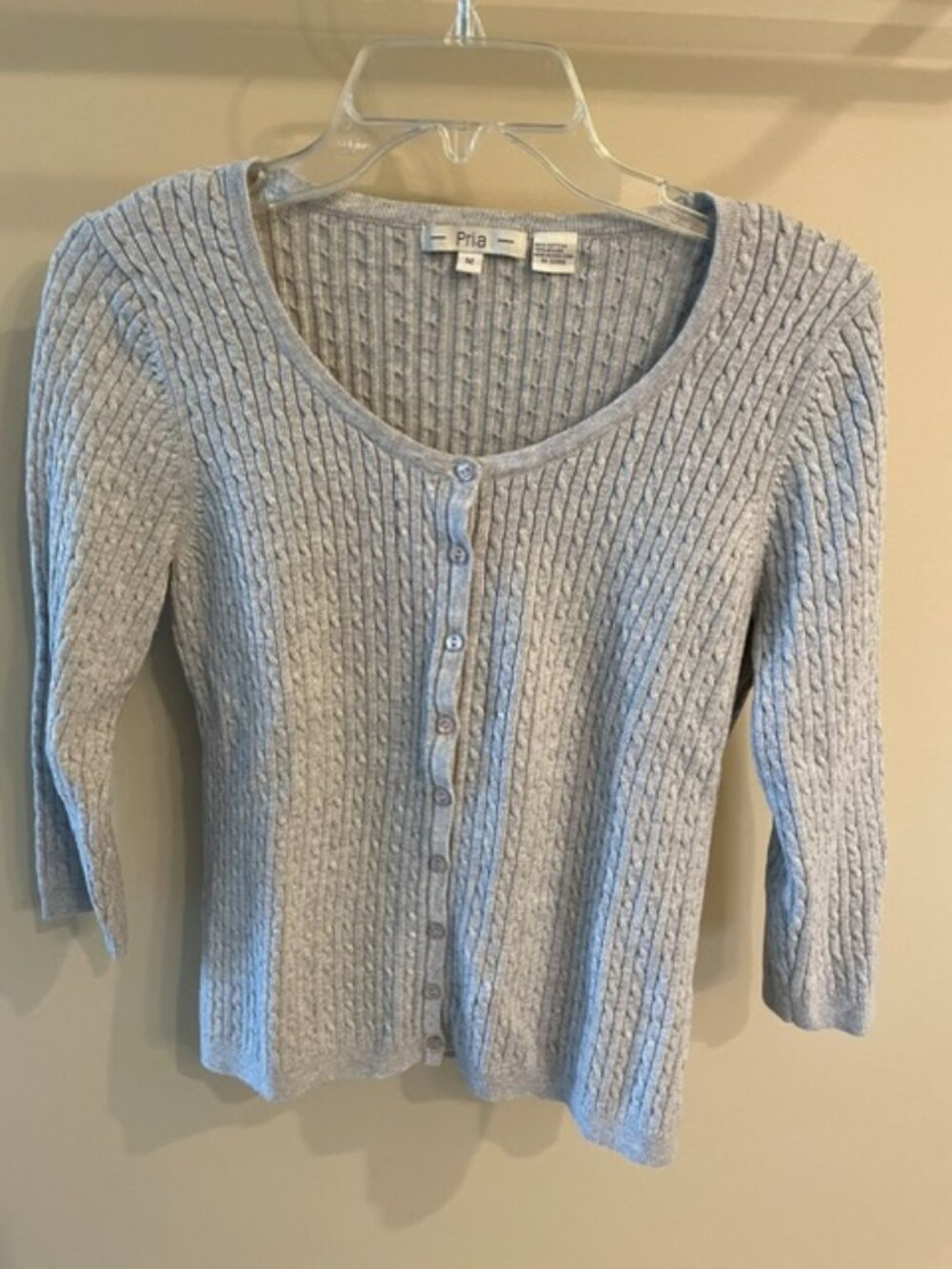 Women's lightweight button front cable sweater with 3/4 sleeves and scoop neck.